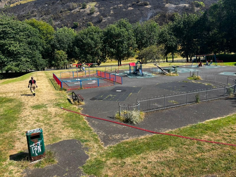 Fire crews ran hoses through a nearby children's playpark as they battled the blaze which had reignited