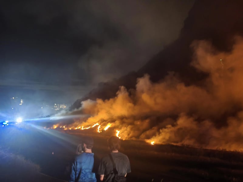 Concerned residents watched on as flames spread across the hill at around midnight