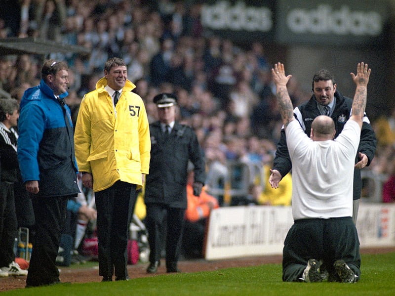 A Newcastle United fan bows in homage in front of the Newcastle dugout.
Coach Terry McDermott, manager Kevin Keegan and smiling stewards looked on during the 5-0 Premier League victory against Manchester United in 1996. (Photo by Stu Forster/Allsport/Hulton Archive/Getty Images)