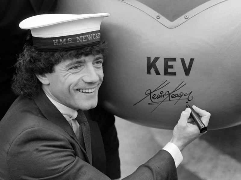 Kevin was pictured wearing an HMS Newcastle hat as he autographed the helicopter which was named after him on HMS Newcastle in 1983. (Photo by Julian Brannigan/Hulton Archive)