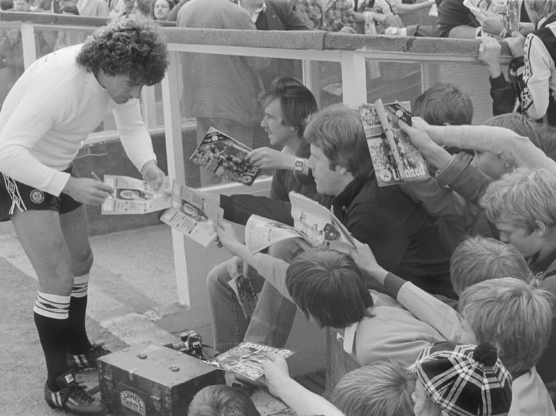 Kevin Keegan signs autographs on match programmes for fans before a Second Division match against Chelsea in 1982. (Photo by Danny Brannigan/Hulton Archive)