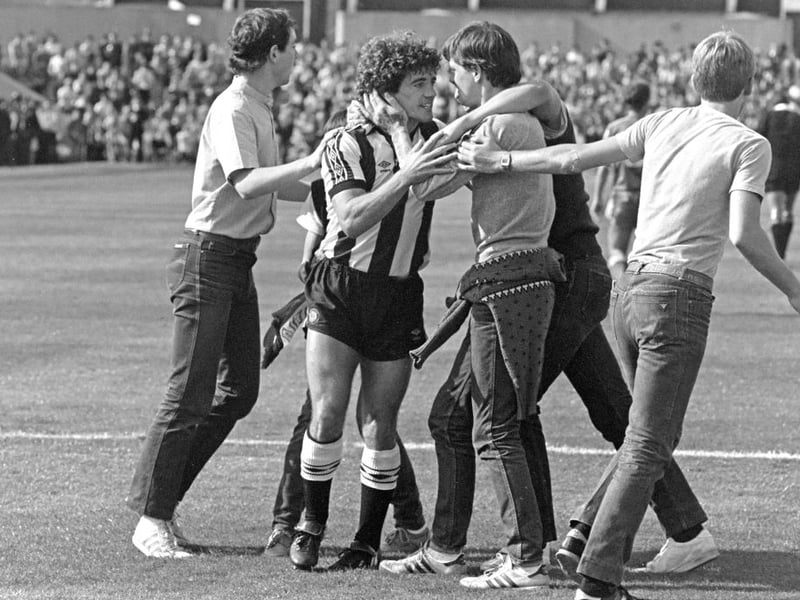 Fans mob their hero after he scored against Queens Park Rangers in 1982. (Photo by Danny Brannigan/Hulton Archive)