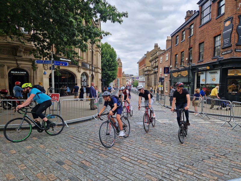 Cyclists in the community ride before the Sheffield cycling grand prix turn onto Surrey Street from Norfolk Street. Photo: David Kessen, Iconic Media