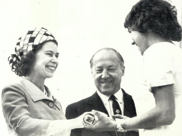 The Queen receieves the Commonwealth Baton at the start of the Games.