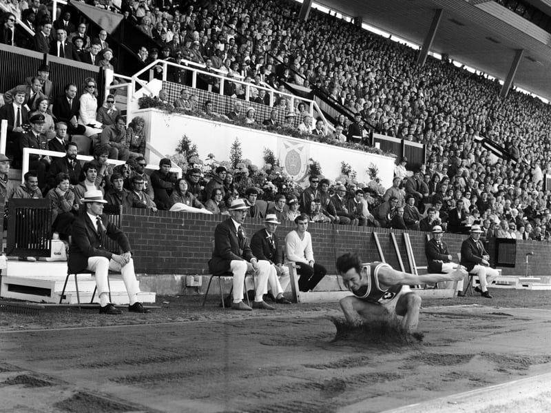 The Royal Family and the crowd watch as Wales' Lynn Davies completes his long jump to take the gold medal at the Commonwealth Games in Edinburgh in 1970.