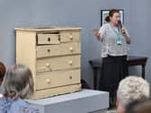 Dolores Lyne explaining the significance of a battered chest of drawers to her granduncle's life.
