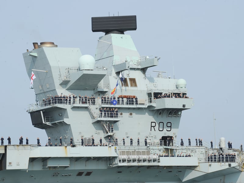 HMS Prince of Wales returned home to HMNB Portsmouth on July 24, 2026, after completing the first phase of Operation Firecrest. Families and friends gathered along the Hot Walls and on The Round Tower in Old Portsmouth to welcome the sailors back to base.