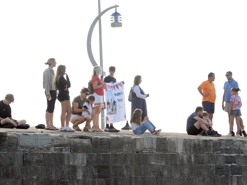 HMS Prince of Wales returned home to HMNB Portsmouth on July 24, 2026, after completing the first phase of Operation Firecrest. Families and friends gathered along the Hot Walls and on The Round Tower in Old Portsmouth to welcome the sailors back to base.