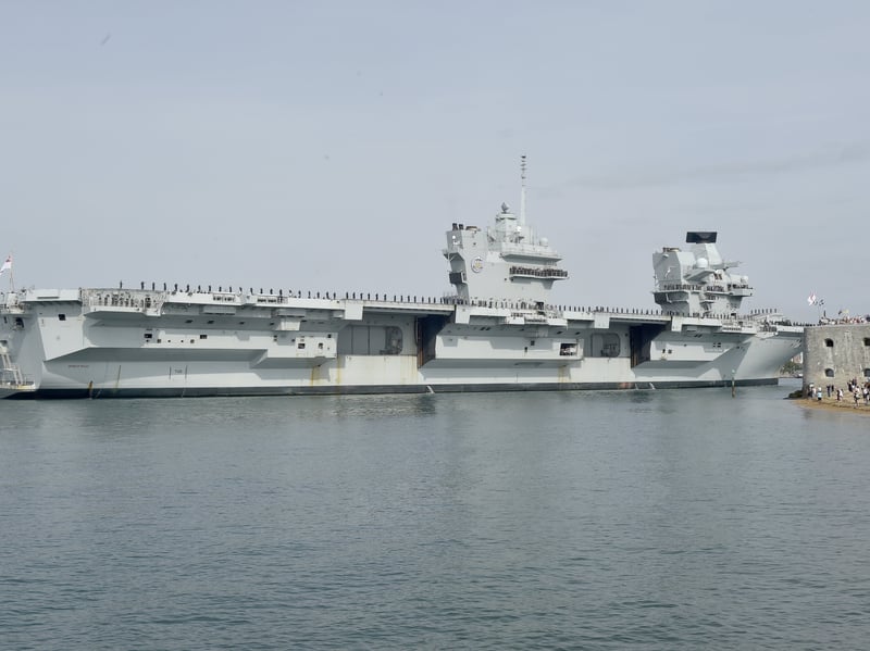 HMS Prince of Wales returned home to HMNB Portsmouth on July 24, 2026, after completing the first phase of Operation Firecrest. Families and friends gathered along the Hot Walls and on The Round Tower in Old Portsmouth to welcome the sailors back to base.
