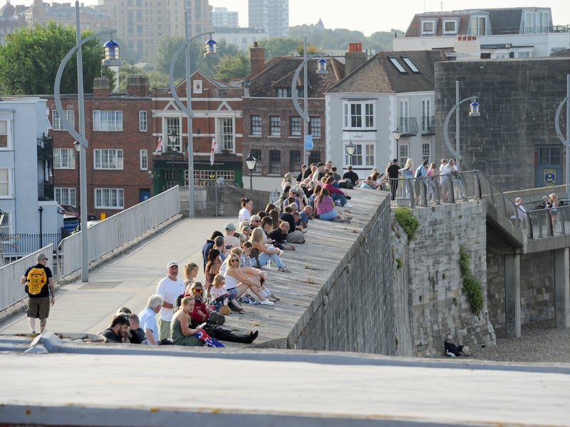 HMS Prince of Wales returned home to HMNB Portsmouth on July 24, 2026, after completing the first phase of Operation Firecrest. Families and friends gathered along the Hot Walls and on The Round Tower in Old Portsmouth to welcome the sailors back to base.