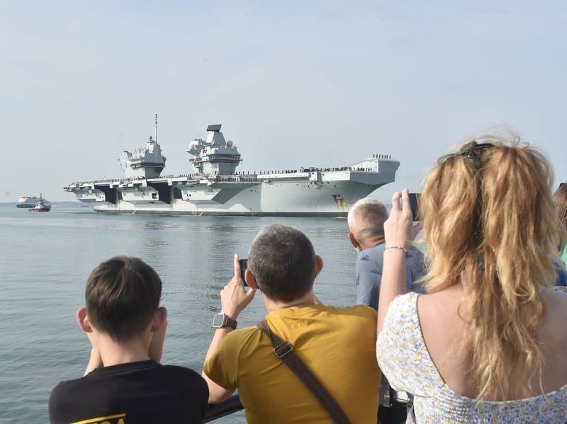 HMS Prince of Wales returned home to HMNB Portsmouth on July 24, 2026, after completing the first phase of Operation Firecrest. Families and friends gathered along the Hot Walls and on The Round Tower in Old Portsmouth to welcome the sailors back to base.