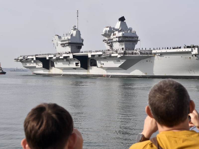 HMS Prince of Wales returned home to HMNB Portsmouth on July 24, 2026, after completing the first phase of Operation Firecrest. Families and friends gathered along the Hot Walls and on The Round Tower in Old Portsmouth to welcome the sailors back to base.