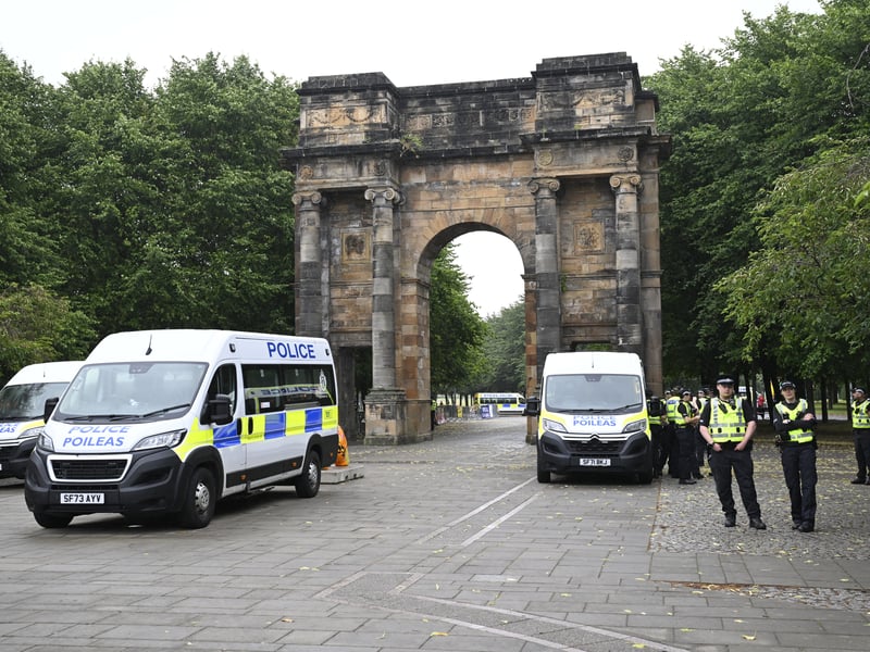 Police officers observe counter protesters from Stand Up To Racism gathered ahead of the Unite the Clans Scotland anti-immigration protest, at Glasgow Green. 
