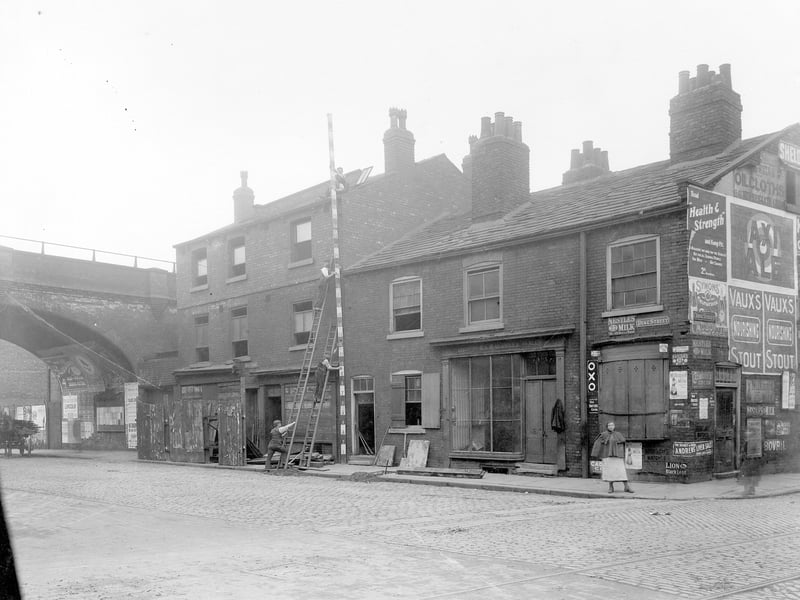 Duke Street junction with York Street in July 1907. Railway bridge to left, the building to the left, to be demolished, is labelled Mays Yard. A group of men measure the building at 27ft high.