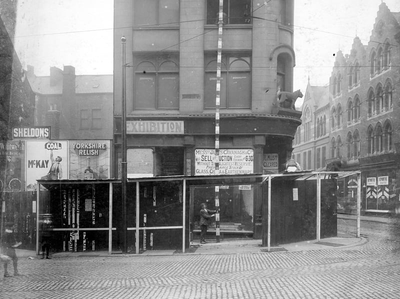 The corner of Kirkgate with New Market Street. Former Tiger Stores on corner with statue of Tiger visible above first storey. Visible on New Market Street is J. Hepworth and sons clothiers and R. Sinclair, tobacco manufacturers. Pictured in July 1907.