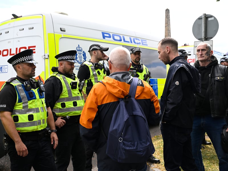 Police officers speak to protesters during an anti-immigration protest, organised by Unite the Clans Scotland, in Glasgow