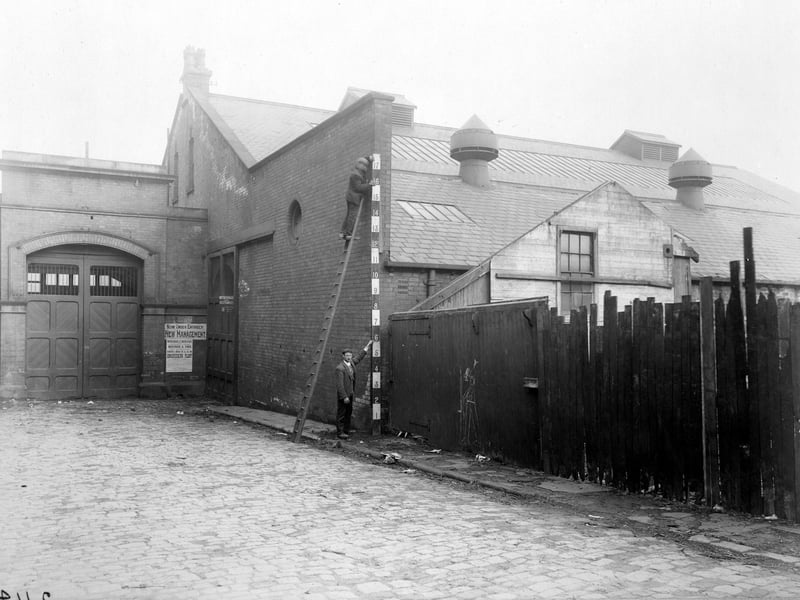 Sheepshanks Yard in May 1907. It was formerly used as North Street Tram Depot, this view shows workmen measuring building. All this property was entirely demolished in 1967 to build the Inner Ring Road.