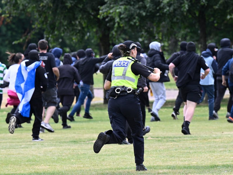 Protesters run from police during an anti-immigration protest, organised by Unite the Clans Scotland, at Glasgow Green