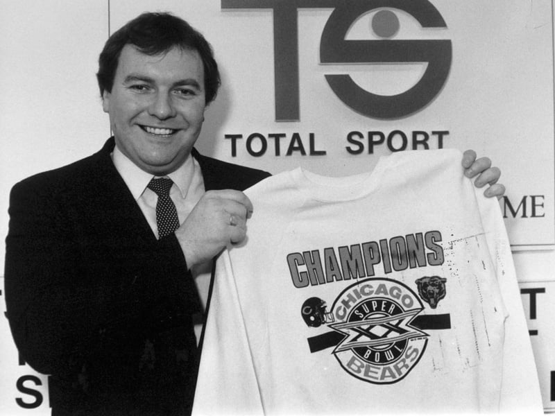 March 1986 and Duncan Revie, son of the former Leeds United and England  manager Don Revie holds up a sweatshirt marking the achievement Super bowl champions the Chicago Bears.