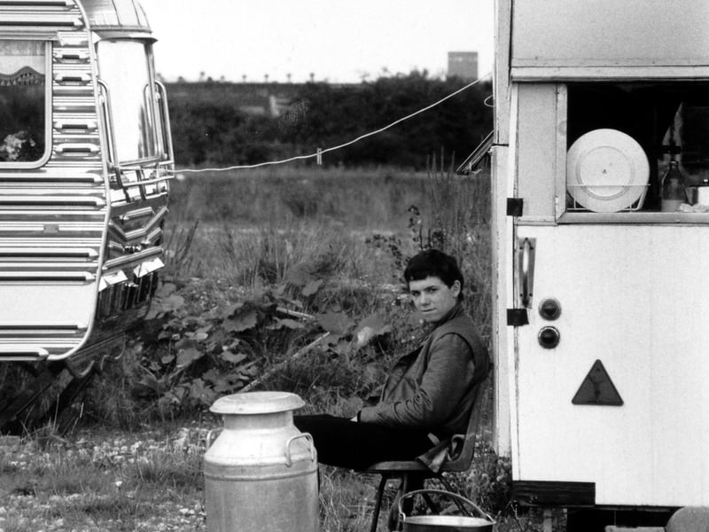 August 1986 and a a boy is pictured sitting at a Leeds roadside site used by gypsies and travellers.