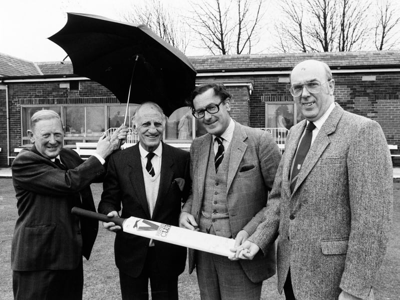 Apri 1986 and Sir Leonard Hutton went back to his nursery club with Yorkshire president Viscount Montgarret to open the new clubhouse extension at Pudsey St. Lawrence. Sheltering under an umbrella, from left, are Richard Smith, club president, Sir Leonard, Lord Mountgarret and Keith Moss, club chairman.