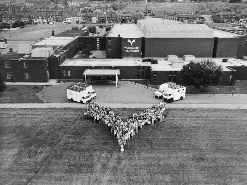 Yorkshire Television staff line up outside their headquarters on Kirkstall Road in the shape of the YTV emblem in August 1986.