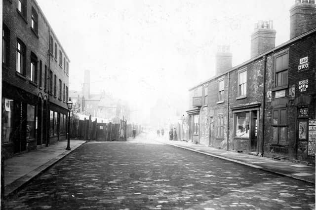 Taken prior to the Hope Street improvements looking north up Bridge Street, showing retail premises in this predominantly Jewish quarter. Shops visible are: Morris Hyman, tailors trimmings: Max Philips, confectioner: Ralph Levi, bookseller.