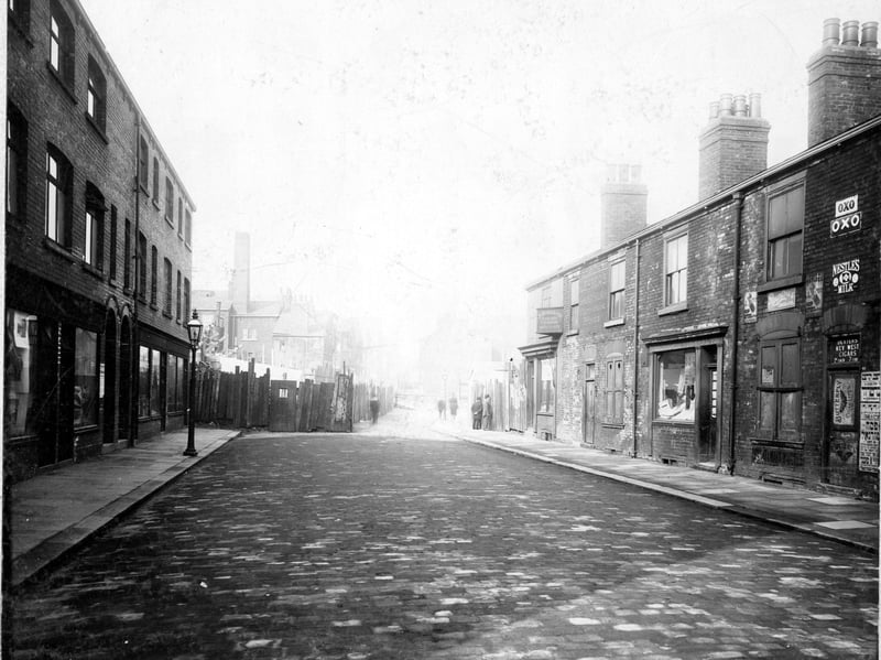 Taken prior to the Hope Street improvements looking north up Bridge Street, showing retail premises in this predominantly Jewish quarter. Shops visible are: Morris Hyman, tailors trimmings: Max Philips, confectioner: Ralph Levi, bookseller.