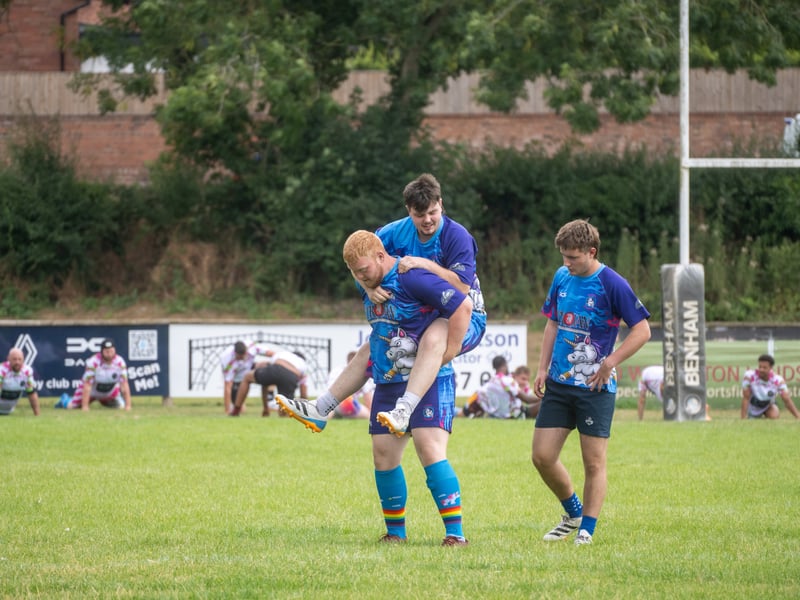One player gives his team mate at lift at the Will Rogers Memorial Tournament
