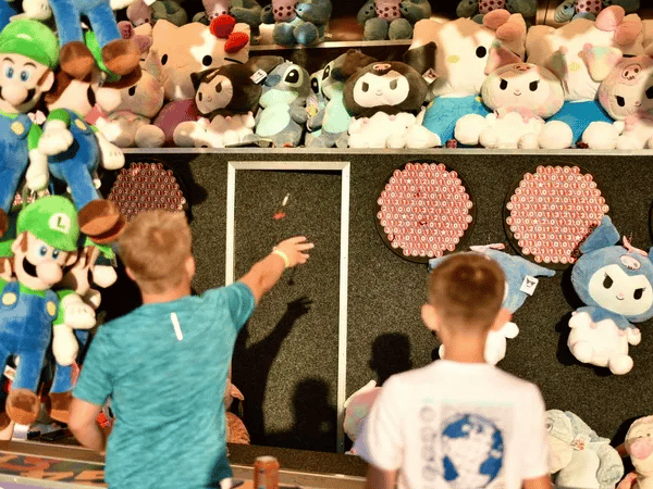 Children playing a darts game.