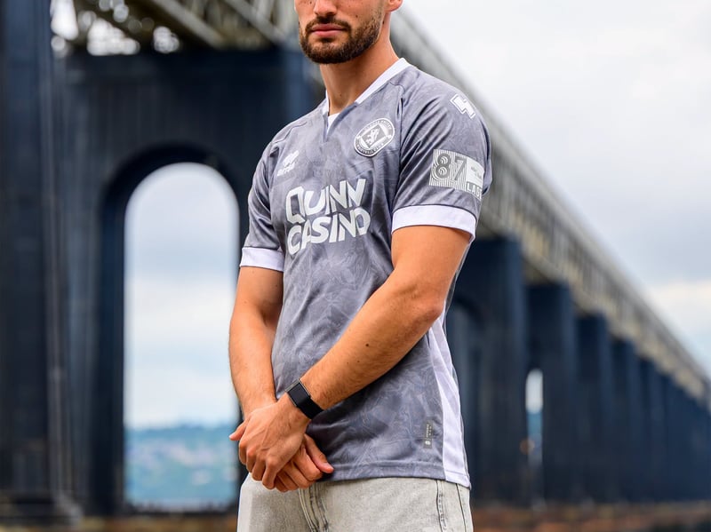 Why Sir Alex Ferguson wasn't a big fan, grey-themed kits were all the rage in the 90s, and they're back in fashion at Tannadice - though this is officially 'silver-grey' with a white colourway. We can understand it might be marmite to some, but we really like this one from Errea. The white detailing on the V-neck collar, sleeve cuffs, and side body panels is crisp, and the minimalist, monochrome club crest is really eye-catching. This shirt retails at £60 for adult sizes.