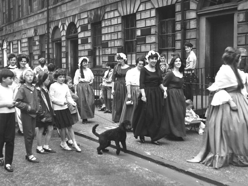 Edinburgh children follow the cast of 'Candida' around the city during the Edinburgh Festival in August 1966.