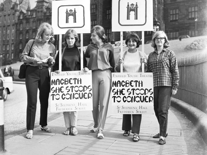 Women from Enfield Youth Theatre wear sandwich boards to promote their productions of 'Macbeth' and 'She Stoops to Conquer' during the Edinburgh Festival 1966.