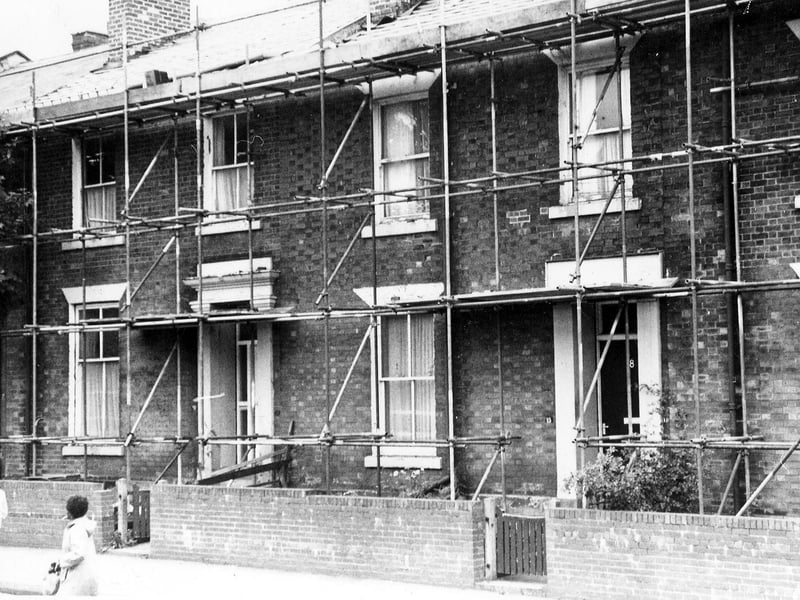 Red brick properties in Cowper Street with scaffolding in place. The Granges Enveloping Programme was part of the Granges Housing Action Area and substantial external work was commencing on stage II at this time in October 1987.