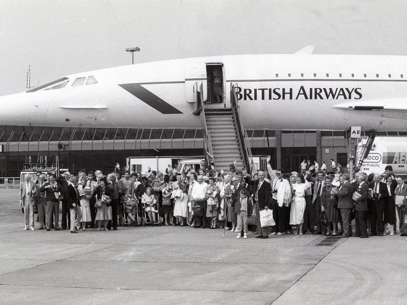  Passengers pose for a group photo ahead of a flight on Concorde. Pictured in April 1987.