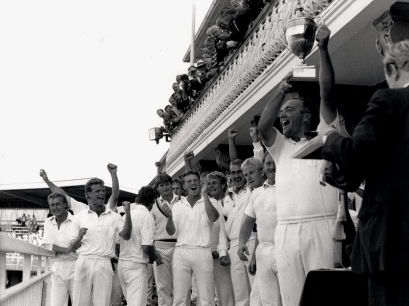 Yorkshire skipper Phil Carrick hoists aloft the Benson and Hedges Cup in 1987, much to the delight of Martyn Moxon, pictured centre.