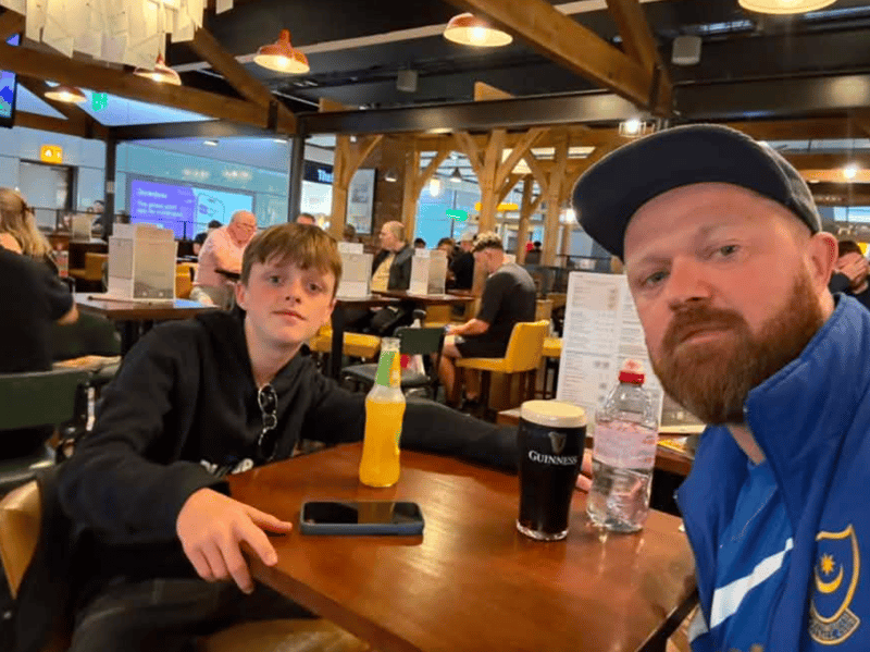 Sam Croucher with the Pompey jacket at the airport.