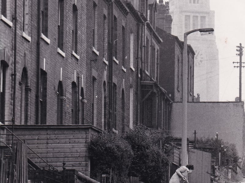 A resident sweeps in July 1972 with the Parkinson Building in the background.