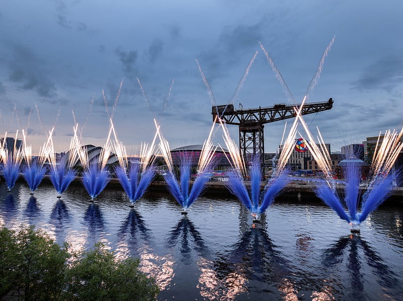 Fireworks in the shape of the Commonwealth Games logo erupt from the Clyde.