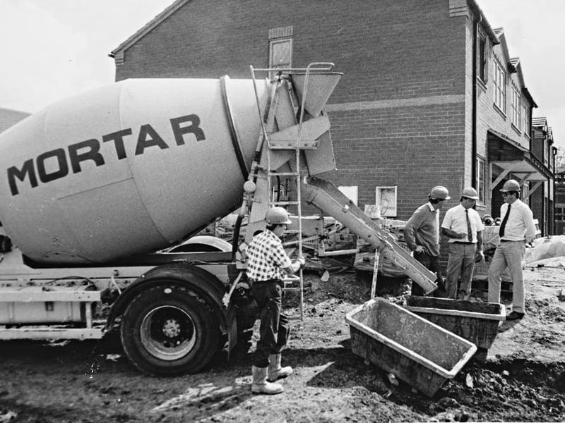 Eugene Peinaar stands alongside David Jones (centre) and Ian Felton at a Walsall Wood building site in May 1990 as ready-to-use mortar is discharged directly from a Hymix mixer lorry into mortar tubs. Operating out of Burntwood, Mortars Plasters and Screeds pioneered the innovative construction technique in collaboration with BT Felton and Sons and South Africa’s Pioneer Concrete. The trial reflected how local trades and building firms embraced new technology to streamline traditional bricklaying and housebuilding methods. Do you remember seeing new construction techniques or specialised delivery lorries like this introduced on building sites back in the 1990s?