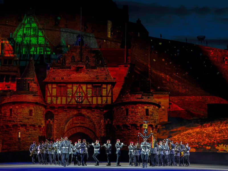 The German Army Band perform against a dramatic backdrop.