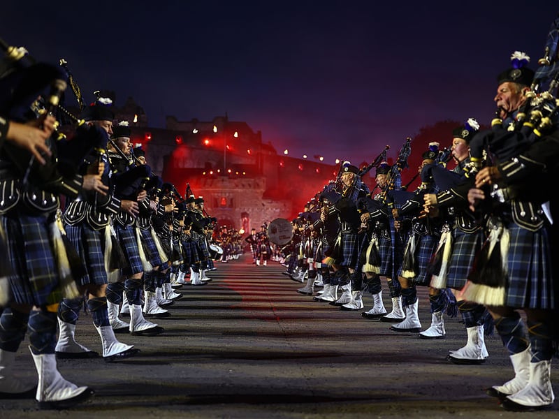 Edinburgh Castle lit up in the background as the pipers play at the Tattoo.