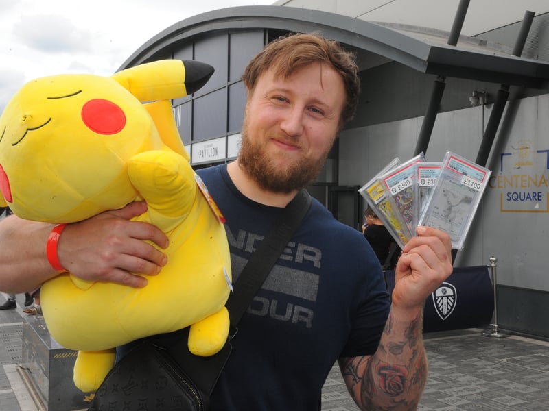 Marcus Lee with his cards and plush Pikachu. 