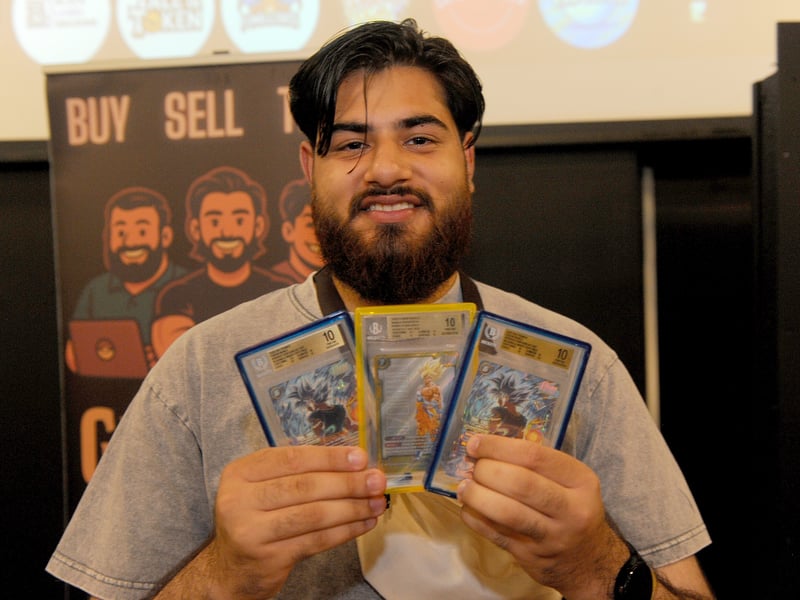 Farzan Arif of The Geek Gym with three Dragon Boat cards worth a total of £60,000 