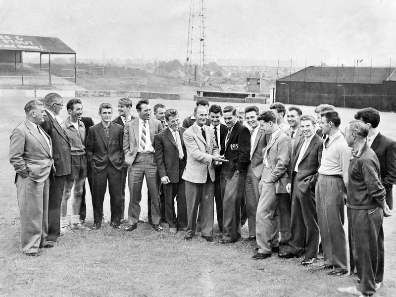 Walsall FC players report back for training at Fellows Park on July 18, 1960, looking sharp in their suits and ties ahead of the new campaign. Manager Bill Moore takes centre stage sharing a joke with the squad, alongside director W. L. Aston, chairman Ernie Thomas, and trainer Vic Potts. Fresh off winning the Fourth Division title, the Saddlers were gathering momentum for another legendary promotion push, capturing a golden era of camaraderie and optimism for the club. Do you remember watching Bill Moore’s famous side during their remarkable rise through the divisions?