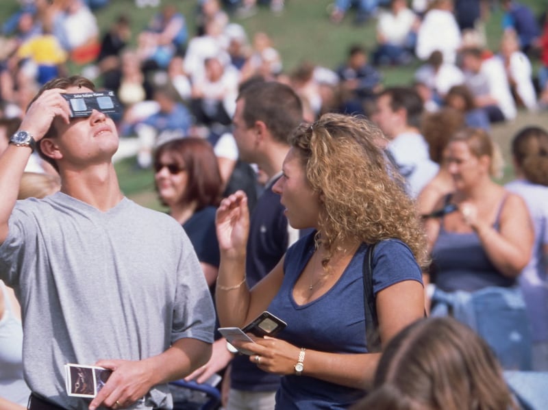 People using their special solar eclipse glasses to look at the sun on Southsea Common Picture: Steve Spurgin

