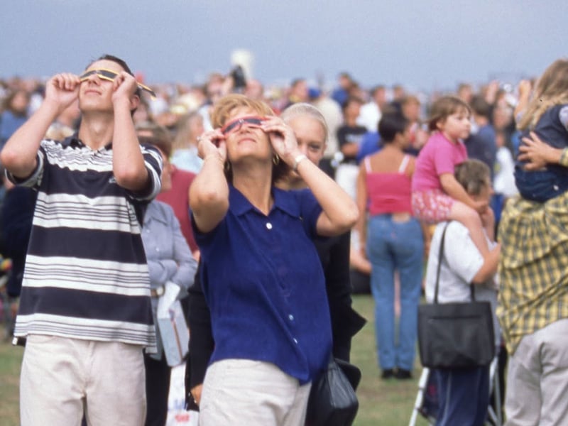 People using their special solar eclipse glasses to look at the sun Picture: Steve Spurgin

