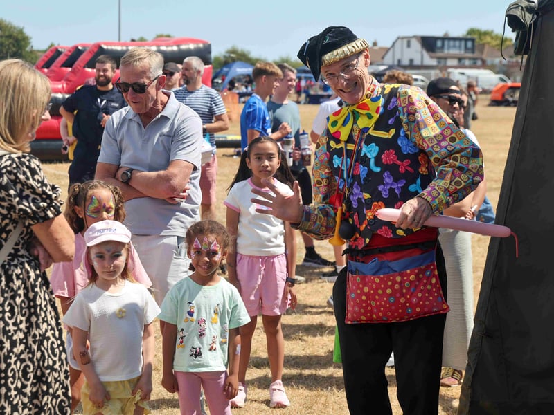 Young visitors engage with the balloon animals stall.