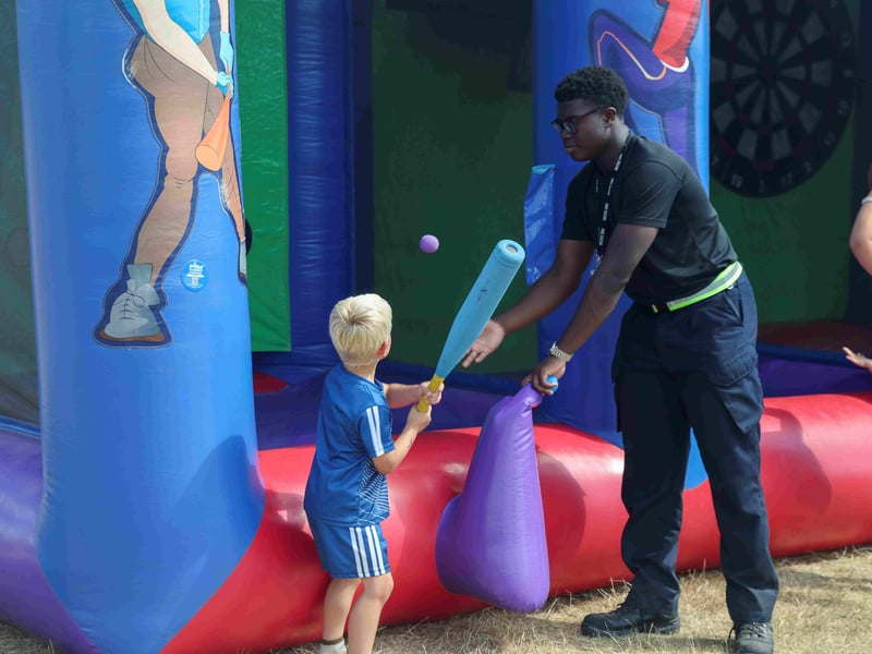 Trainees and families have fun on the inflatables.