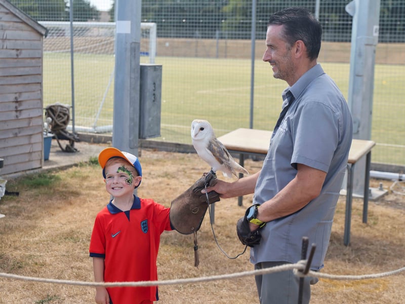 Families get up close to birds of prey at the HMS Sultan Families Day.